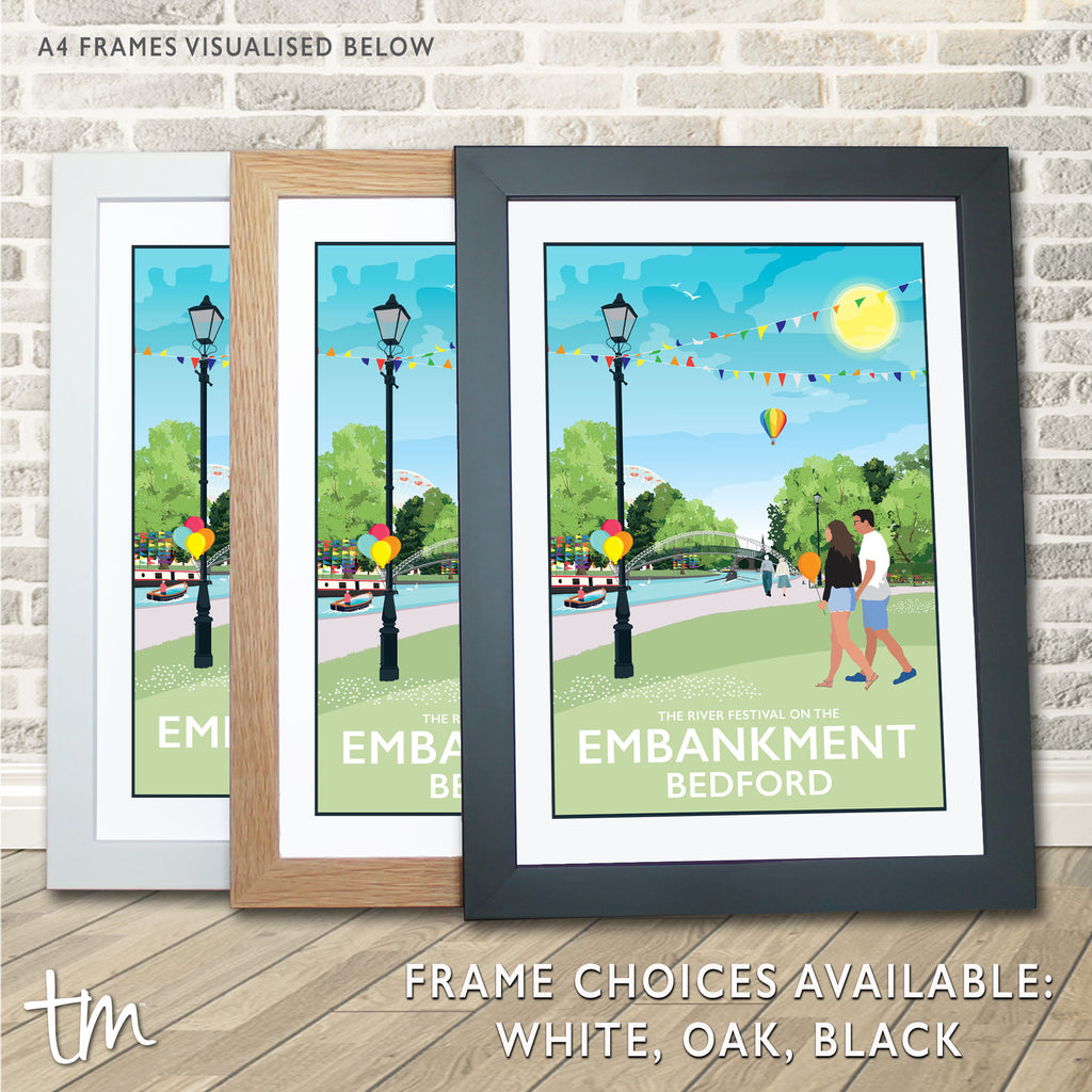 a couple of framed pictures sitting on top of a wooden floor