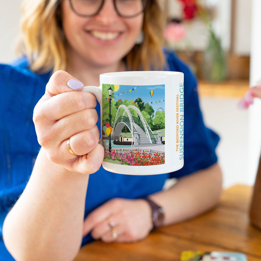 a woman holding a coffee mug with a picture of a fountain
